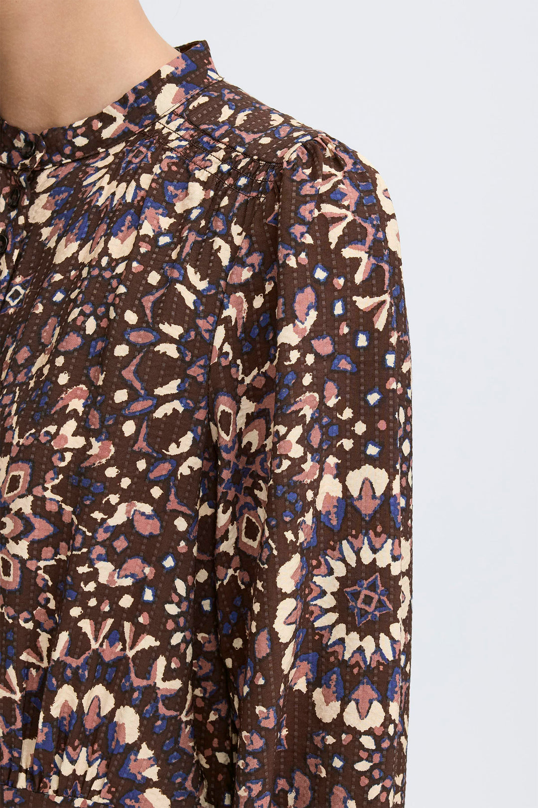 Patterned fabric on a mannequin with a plain background