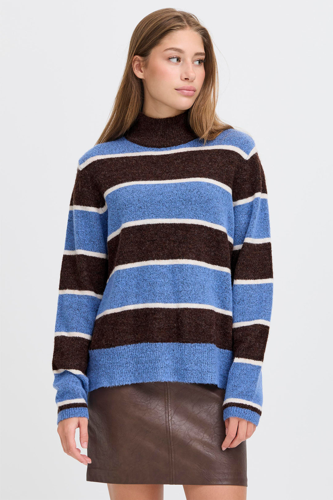 Woman wearing a striped sweater with a plain background