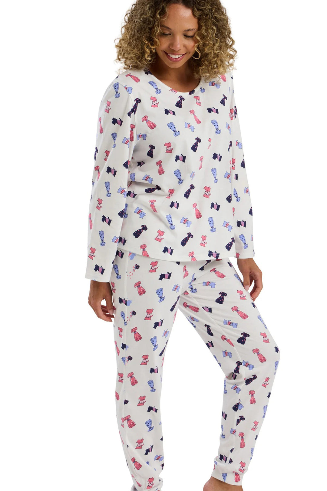 Woman wearing a pajama set with dog and bone pattern on a white background