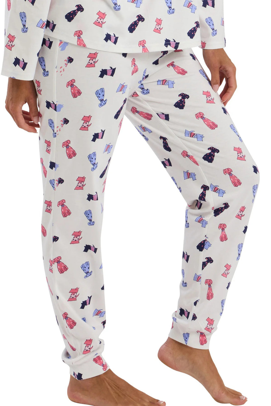 Person wearing pajama pants with a colorful dog pattern on a white background
