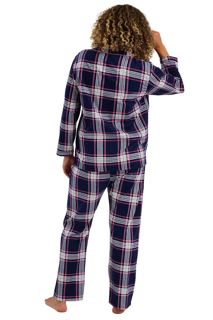 Person wearing a navy and white plaid pajama set on a white background