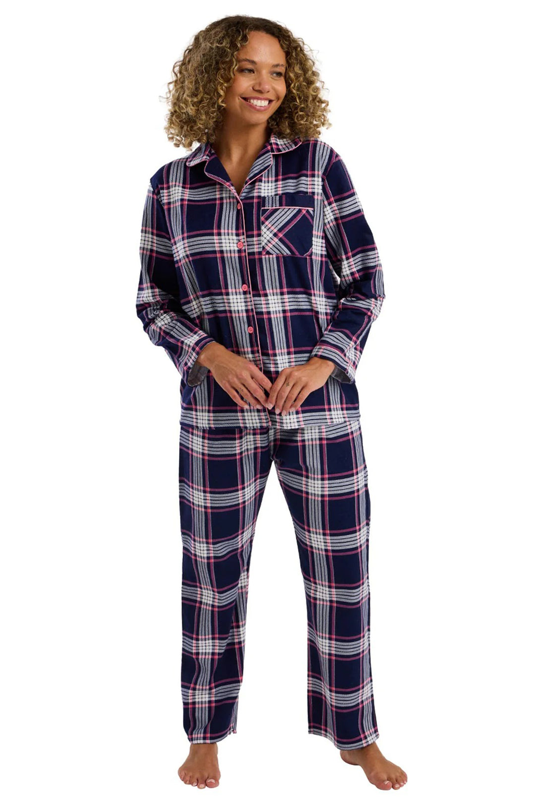 Woman wearing a navy and red plaid pajama set on a white background