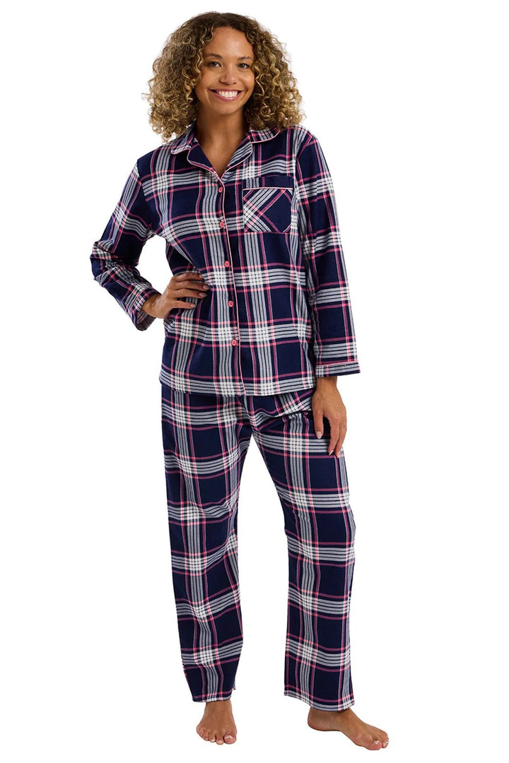 Woman wearing a blue plaid pajama set on a white background