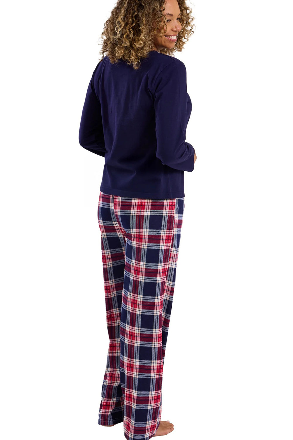 Person wearing a navy long-sleeve top and plaid pants on a white background