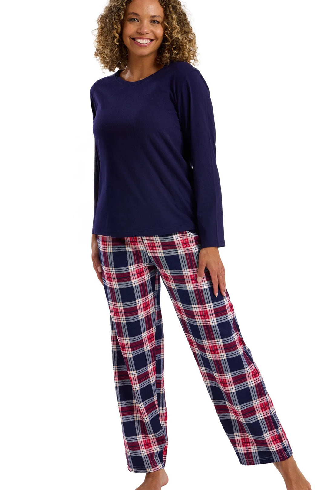 Woman wearing navy long-sleeve top and plaid pants on a white background