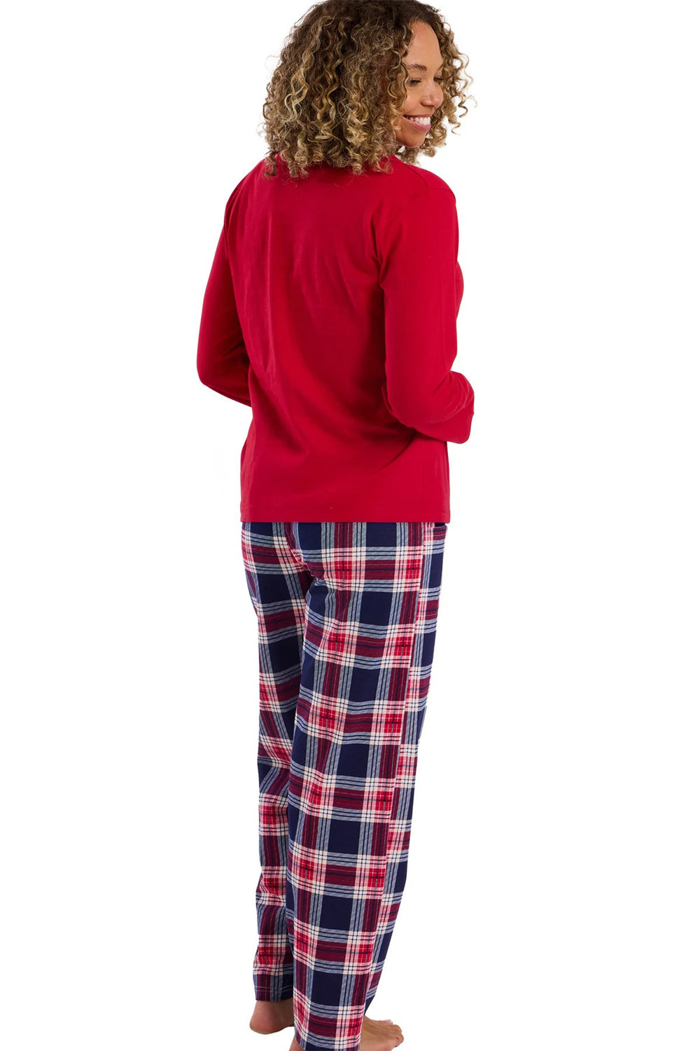 Person wearing a red long-sleeve top and plaid pants on a white background