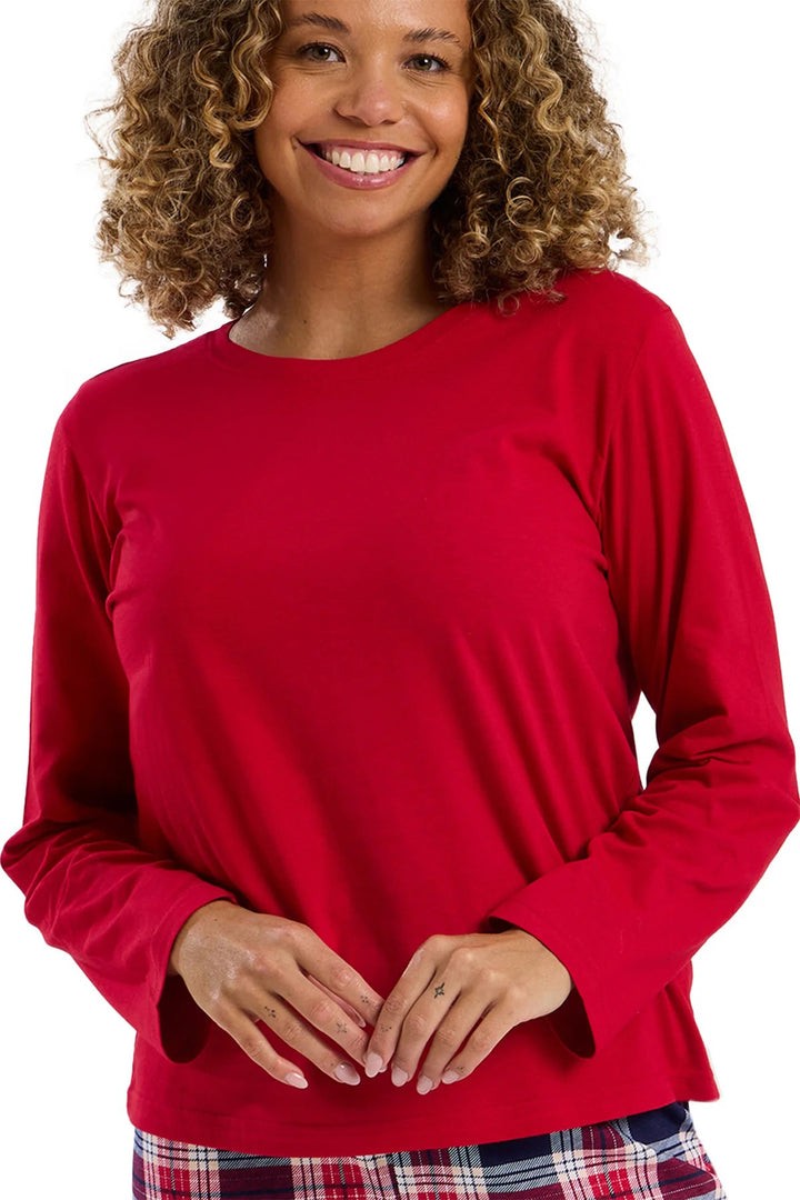 Woman wearing a red long-sleeve top on a white background