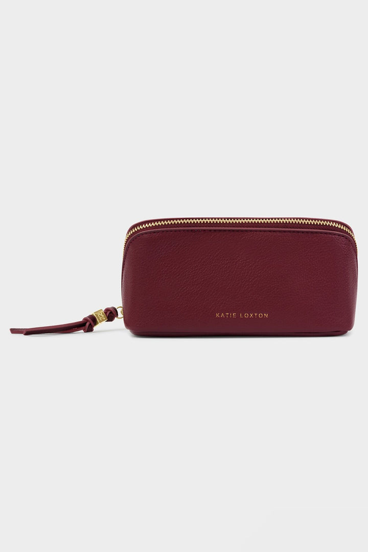 Maroon zippered pouch with brand name on a light gray background