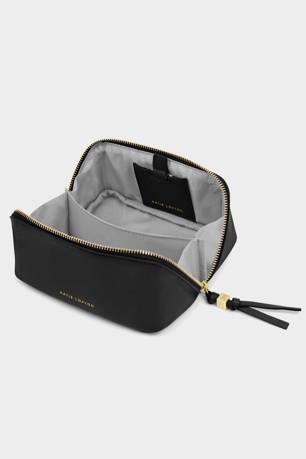 Black cosmetic bag with gold zipper and tassel on a light gray background