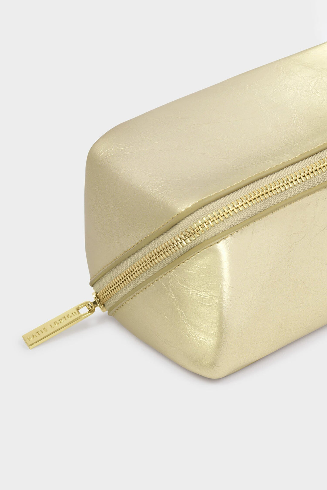 Gold rectangular pouch with zipper on a light gray background