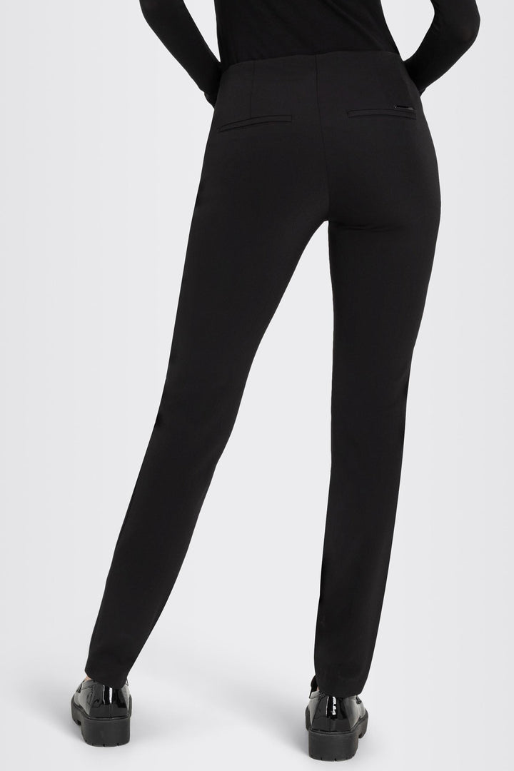 Black pants worn by a person on a white background