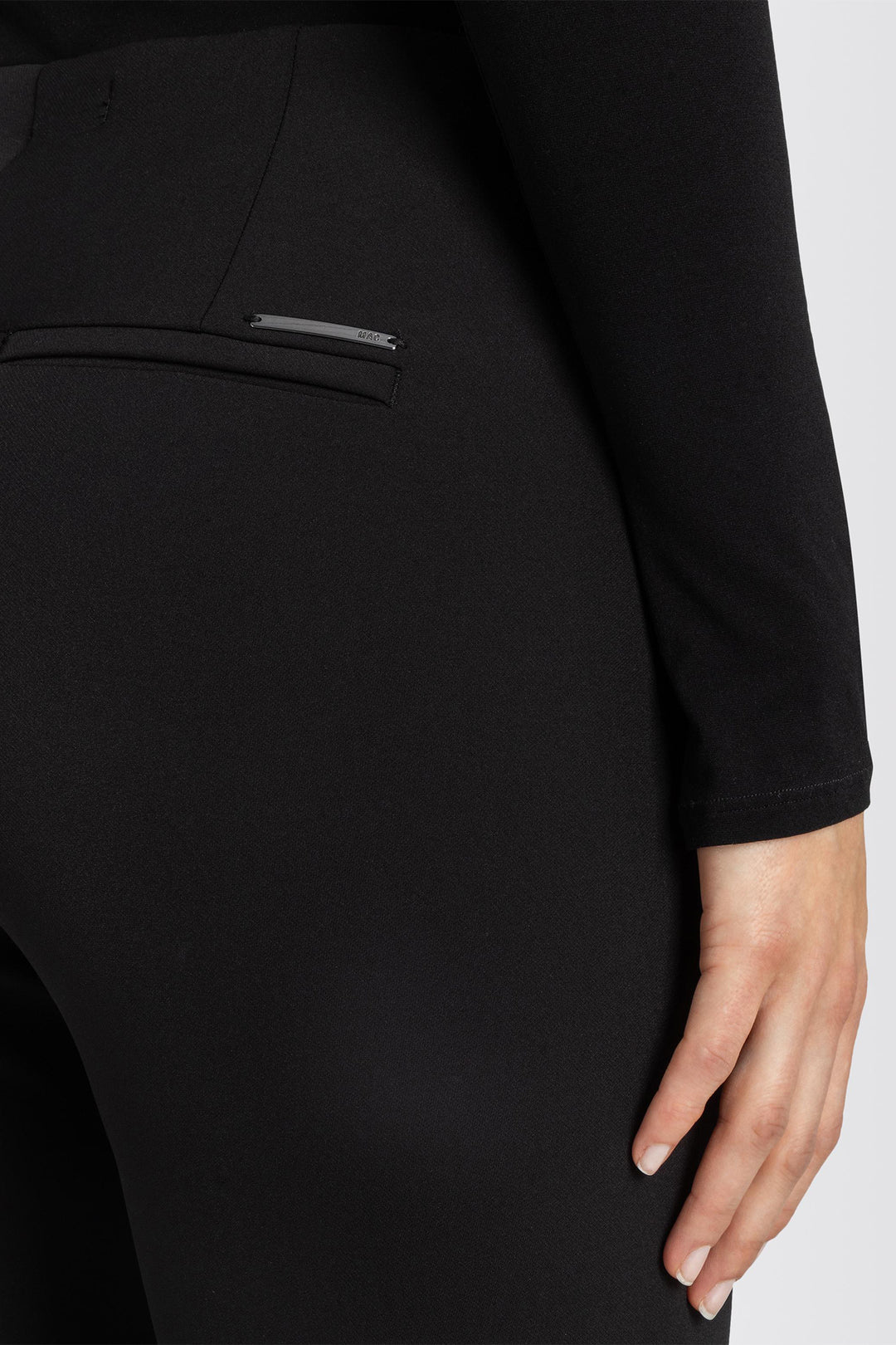 Close-up of a black garment with a hand holding it