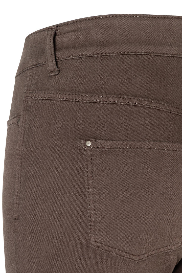 Close-up of brown pants with a pocket and stitching detail on a white background