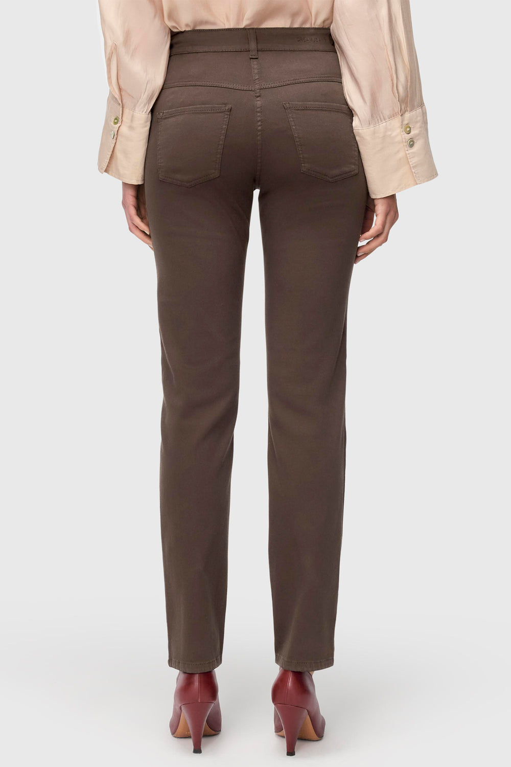 Brown pants worn by a person on a white background