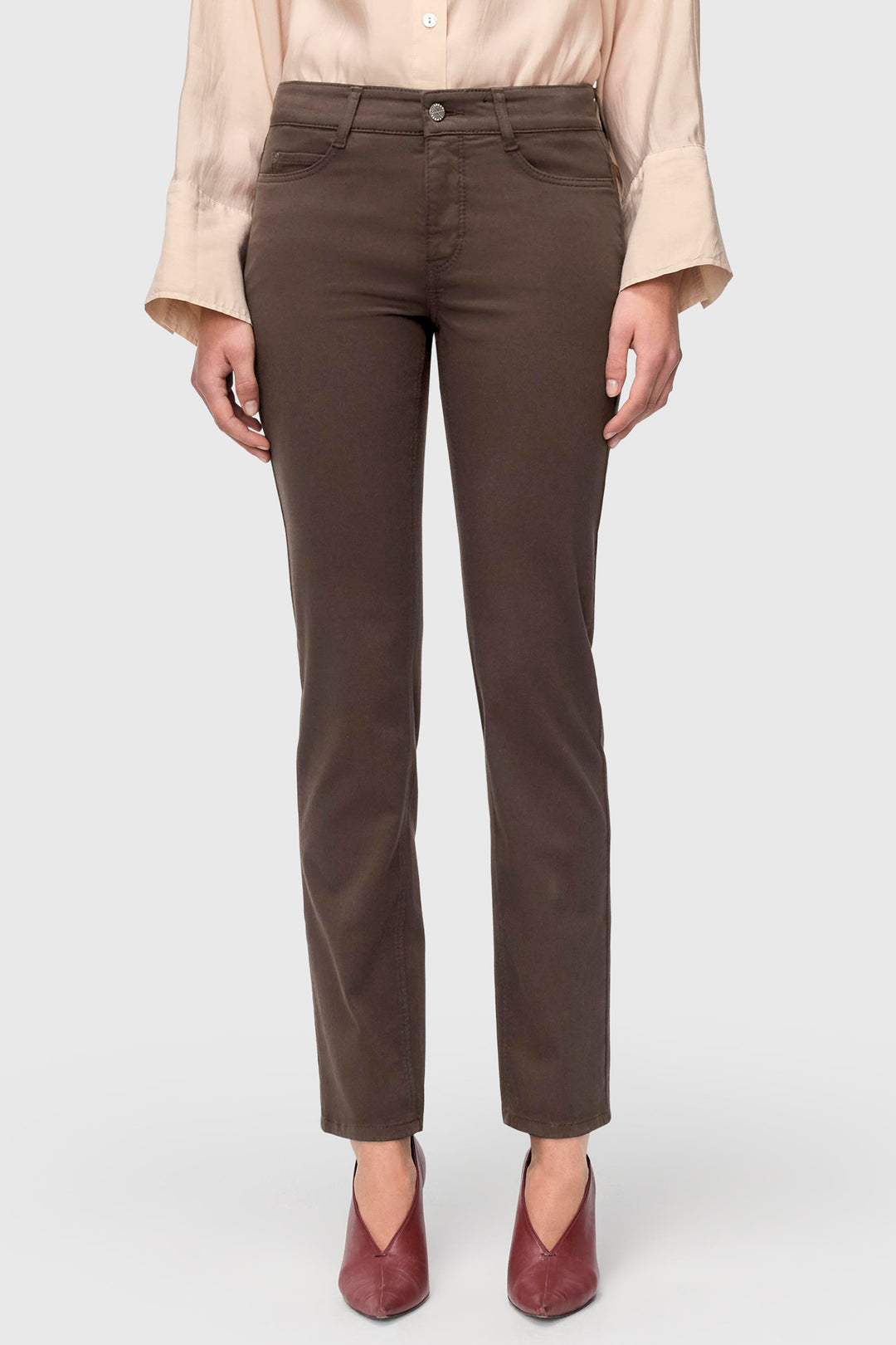 Brown pants worn by a person on a white background