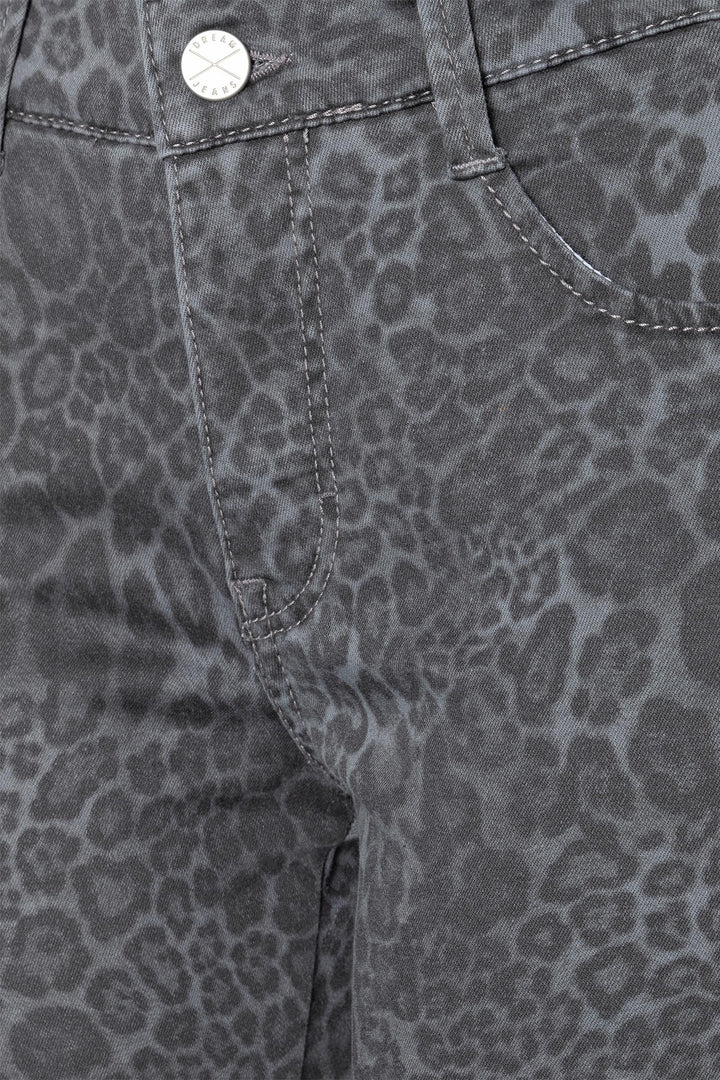 Close-up of gray pants with a subtle leopard print pattern.