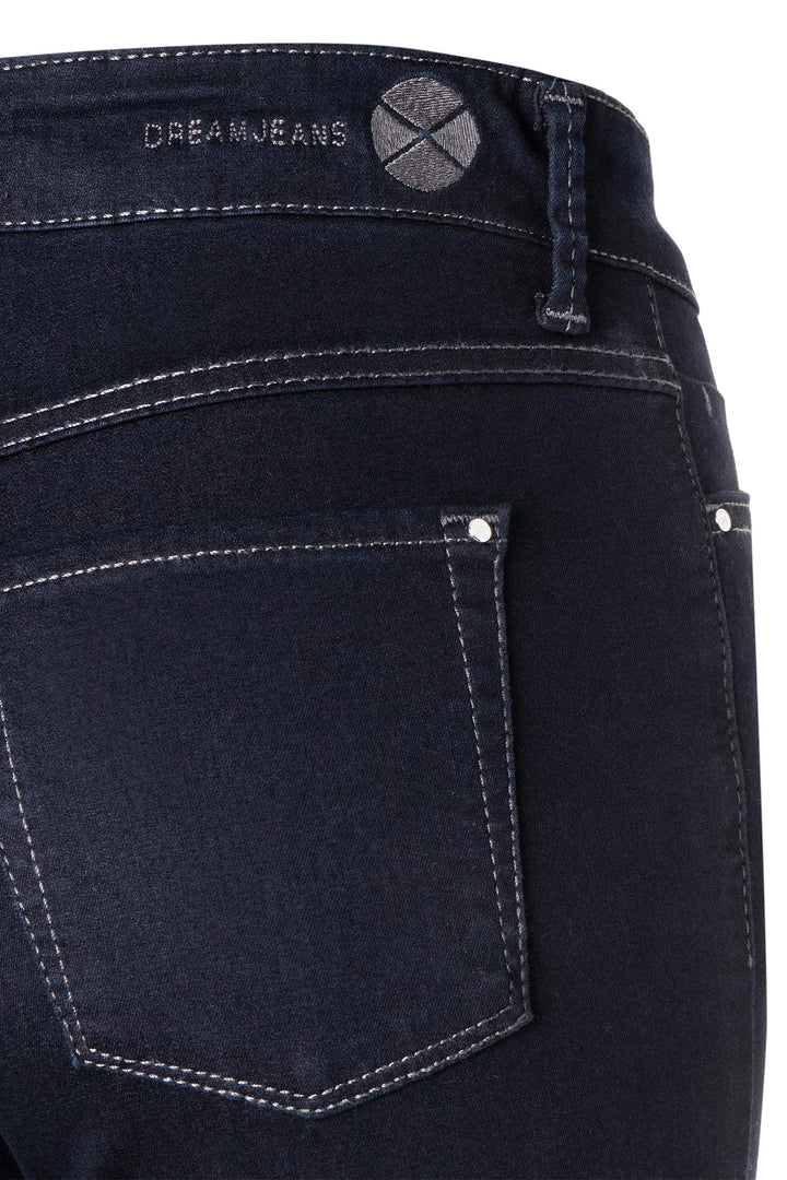 Close-up of black jeans with a visible brand logo on the waistband.