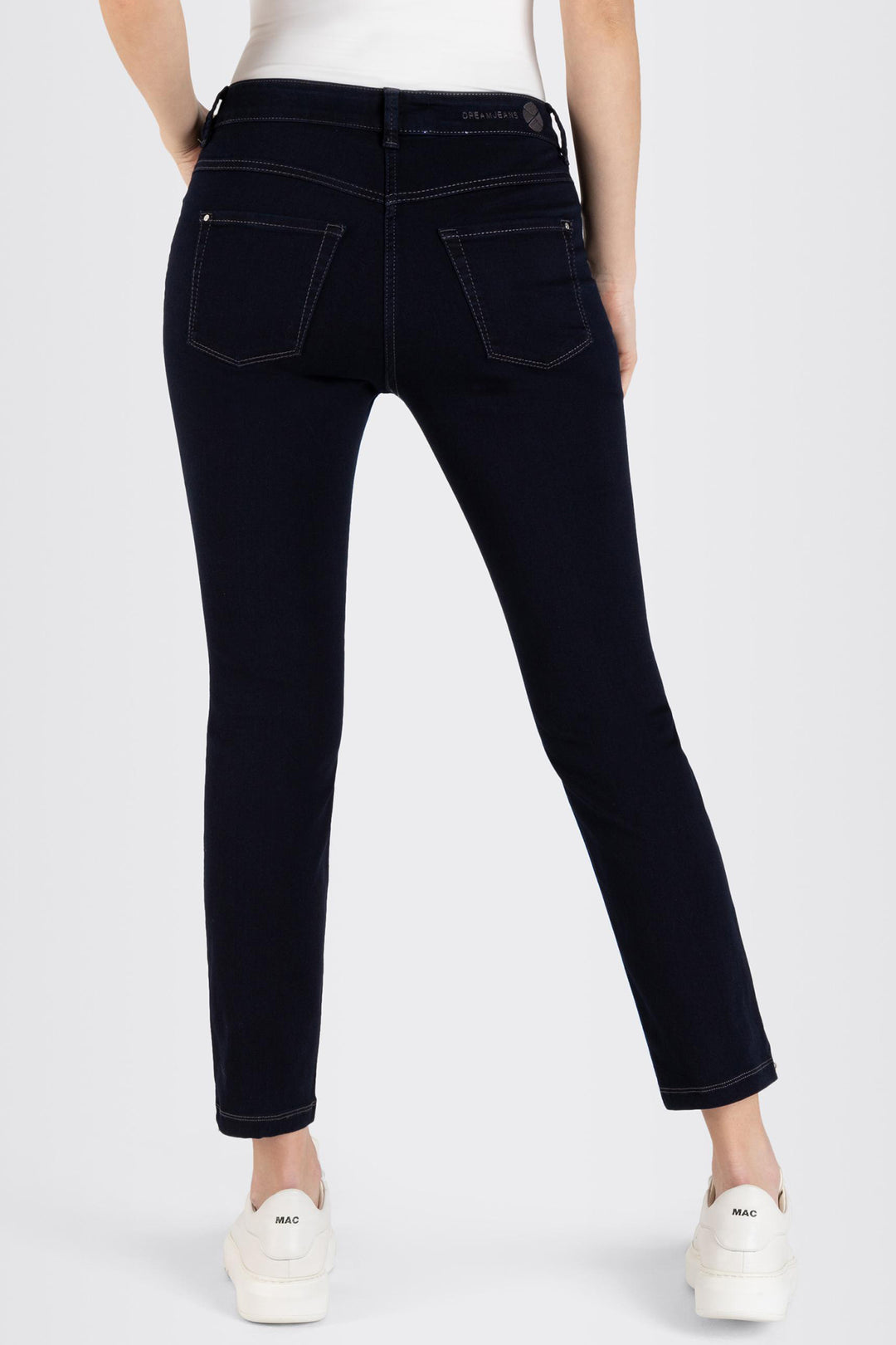 Person wearing black jeans on a white background