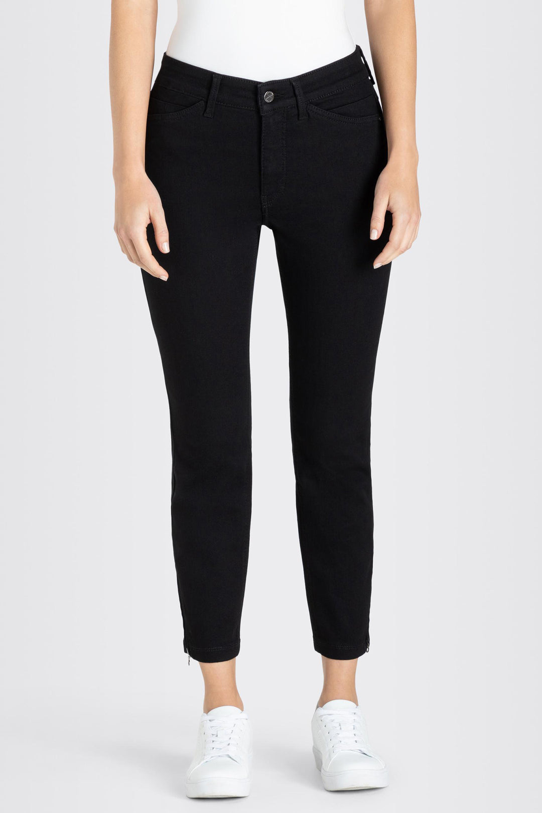 Person wearing black pants on a white background