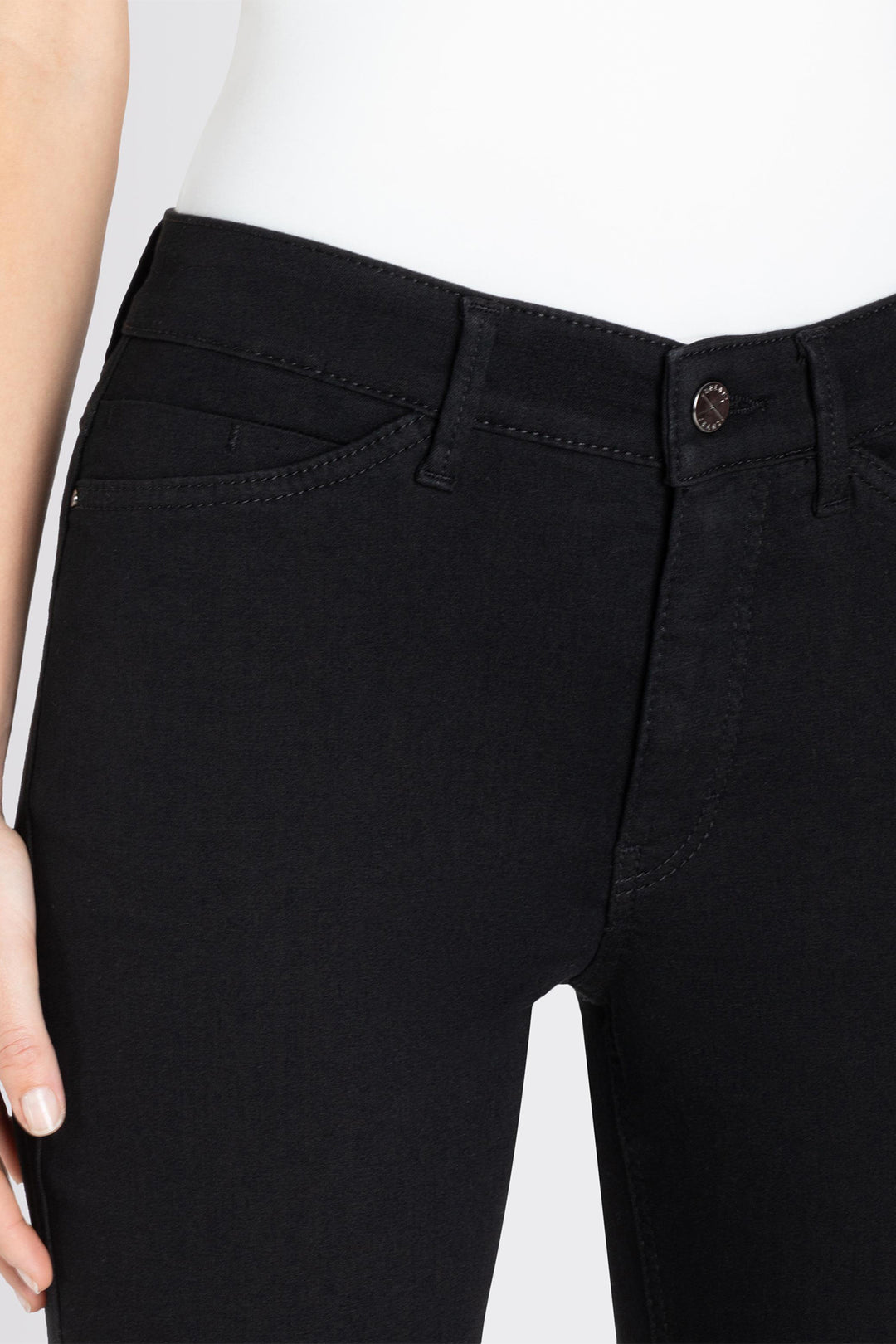 Close-up of black pants with a white background