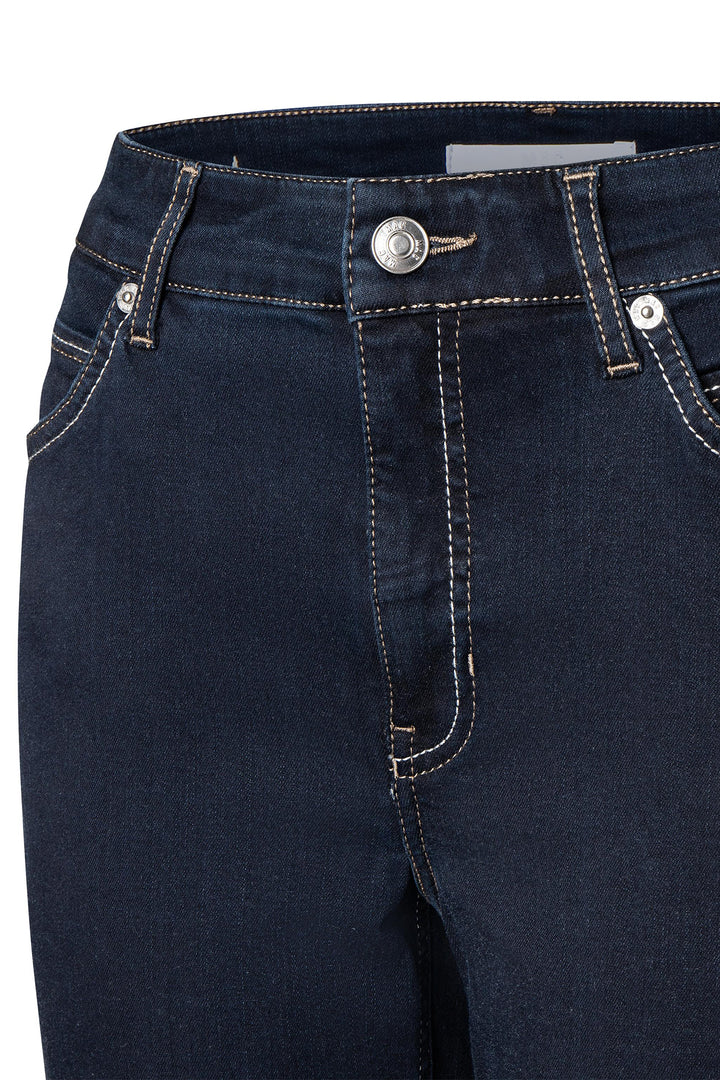 Close-up of dark blue jeans with a button and zipper on a white background