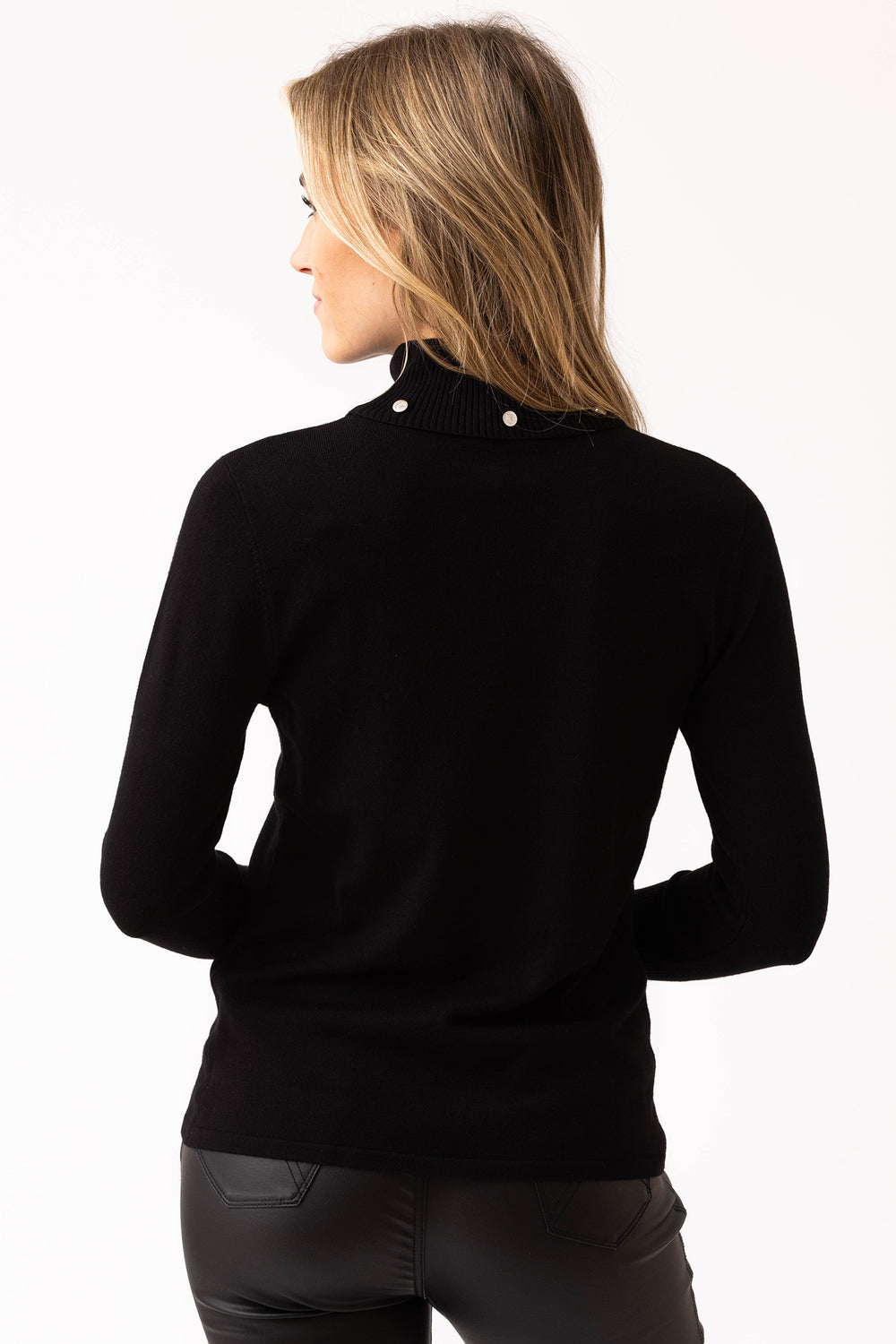 Woman wearing a black turtleneck sweater on a white background