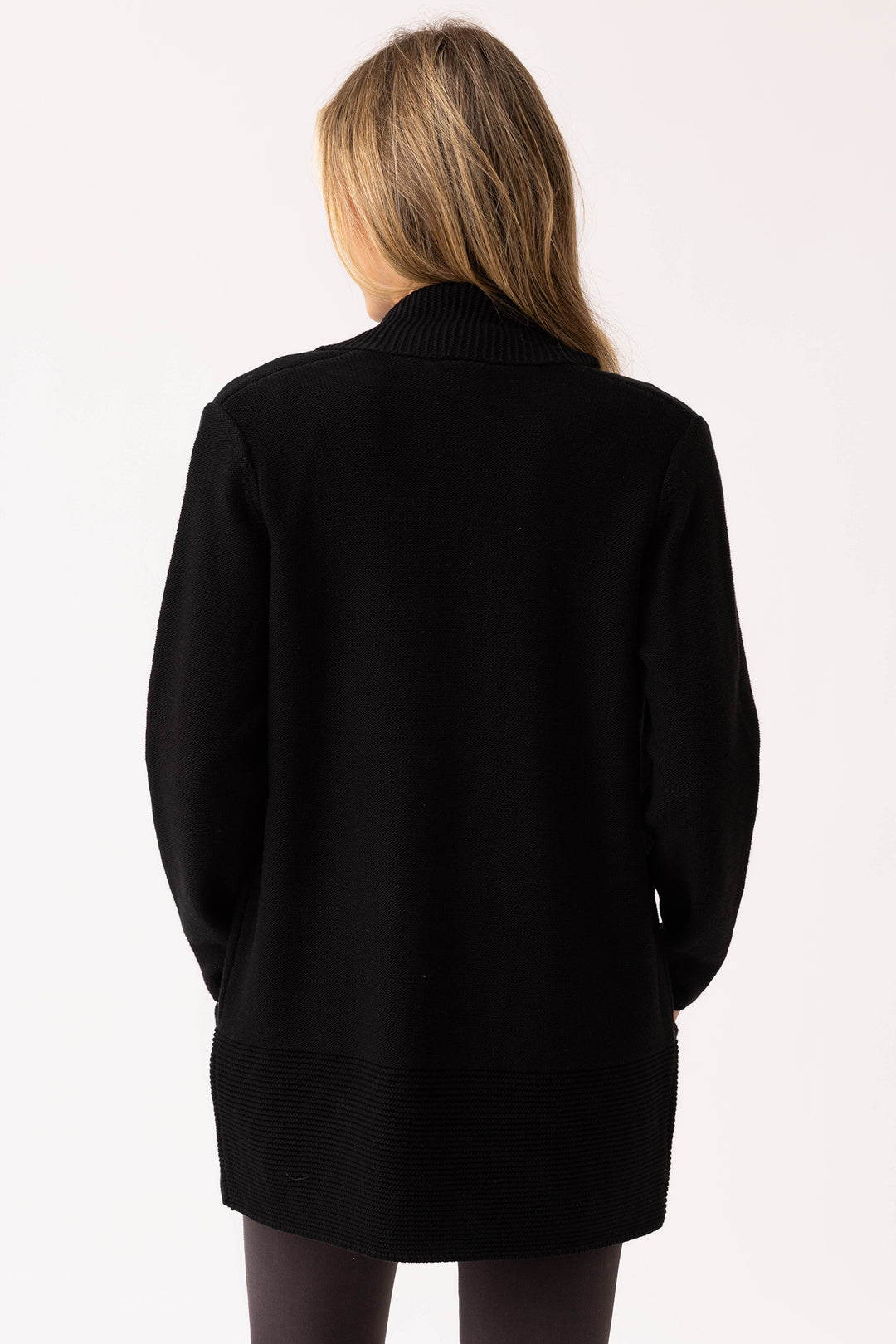 Person wearing a black cardigan on a white background