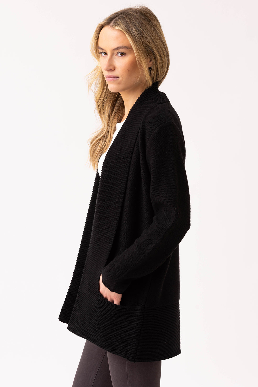 Woman wearing a black cardigan on a white background