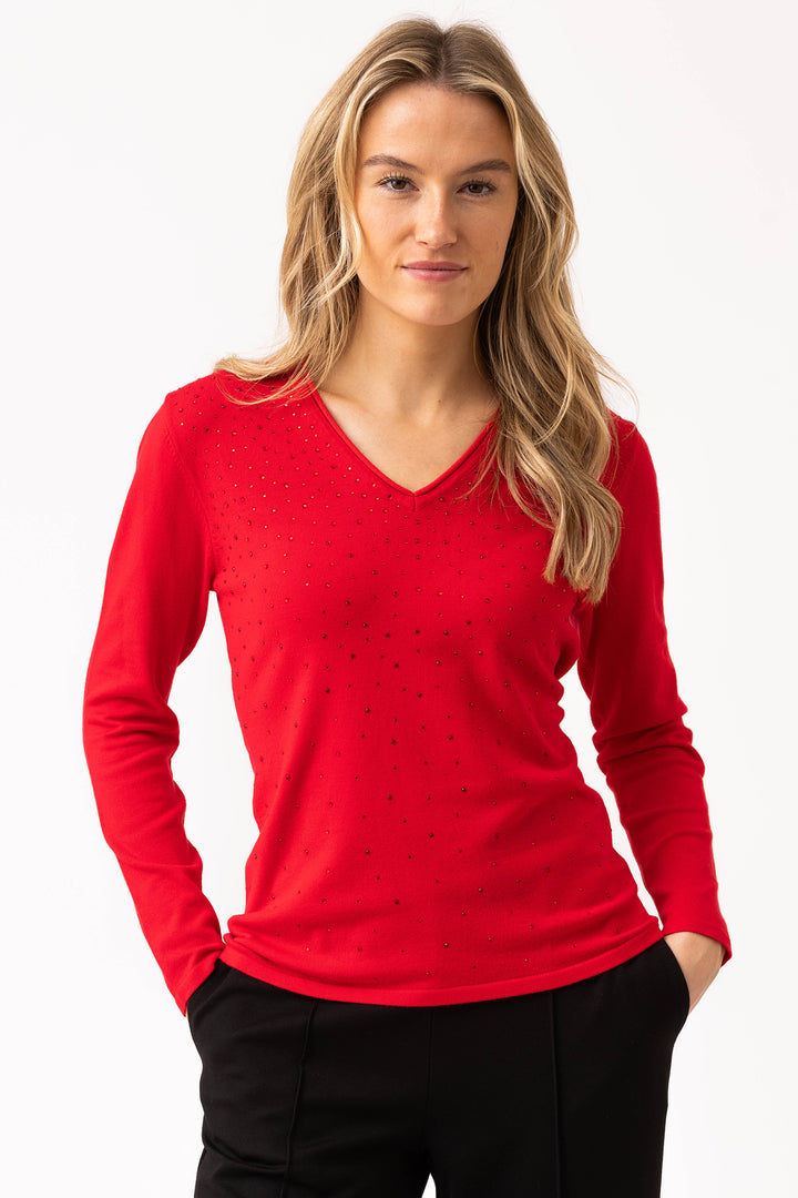 Woman wearing a red long-sleeve top with a white background
