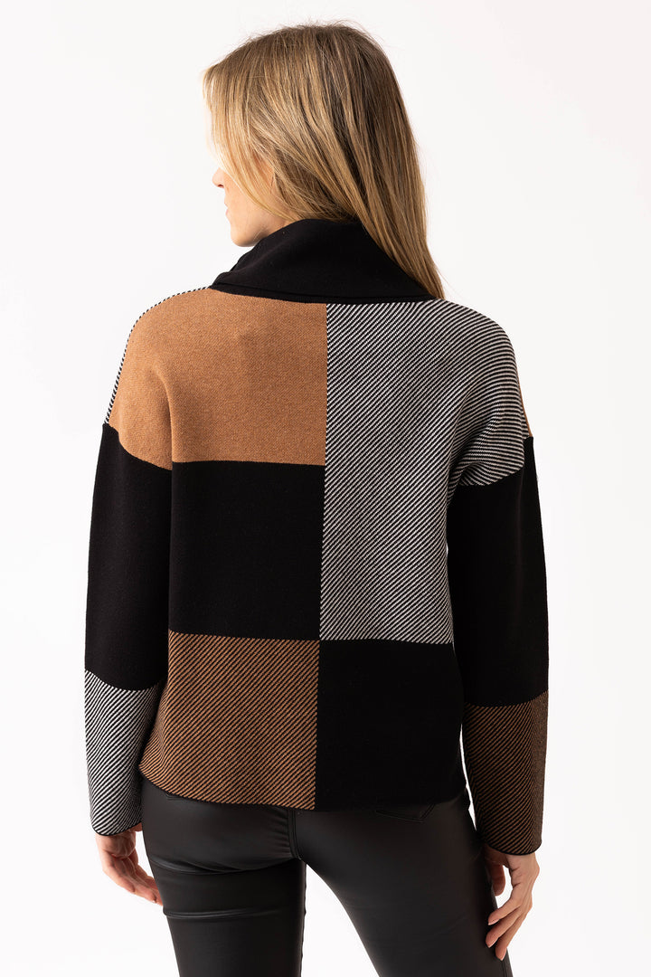 Woman wearing a checkered sweater with brown, black, and gray pattern on a white background