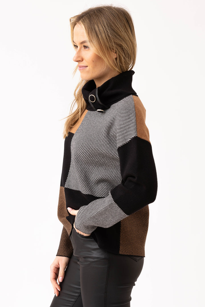 Woman wearing a black, gray, and brown patterned sweater on a white background