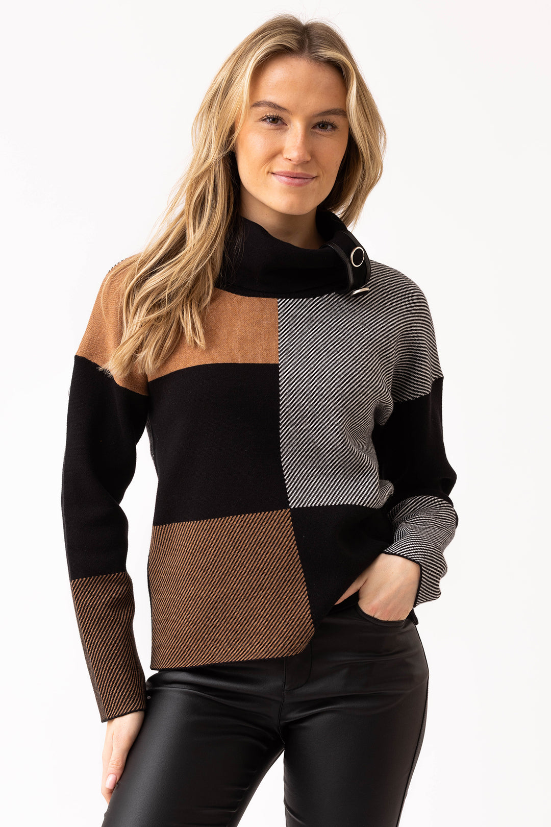 Woman wearing a patchwork sweater with black, brown, and gray colors on a white background