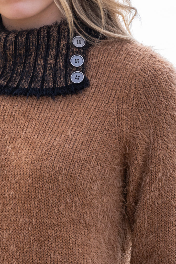 Close-up of a brown knitted sweater with button details