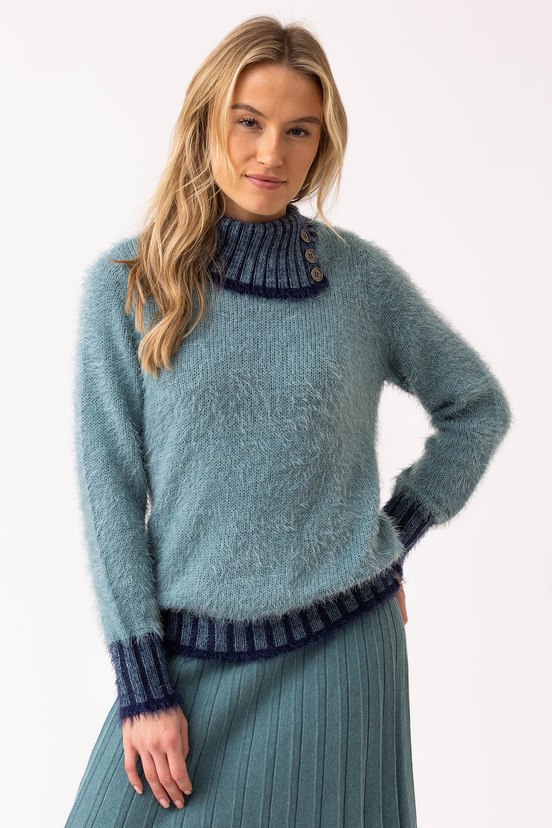 Woman wearing a blue sweater with a white background
