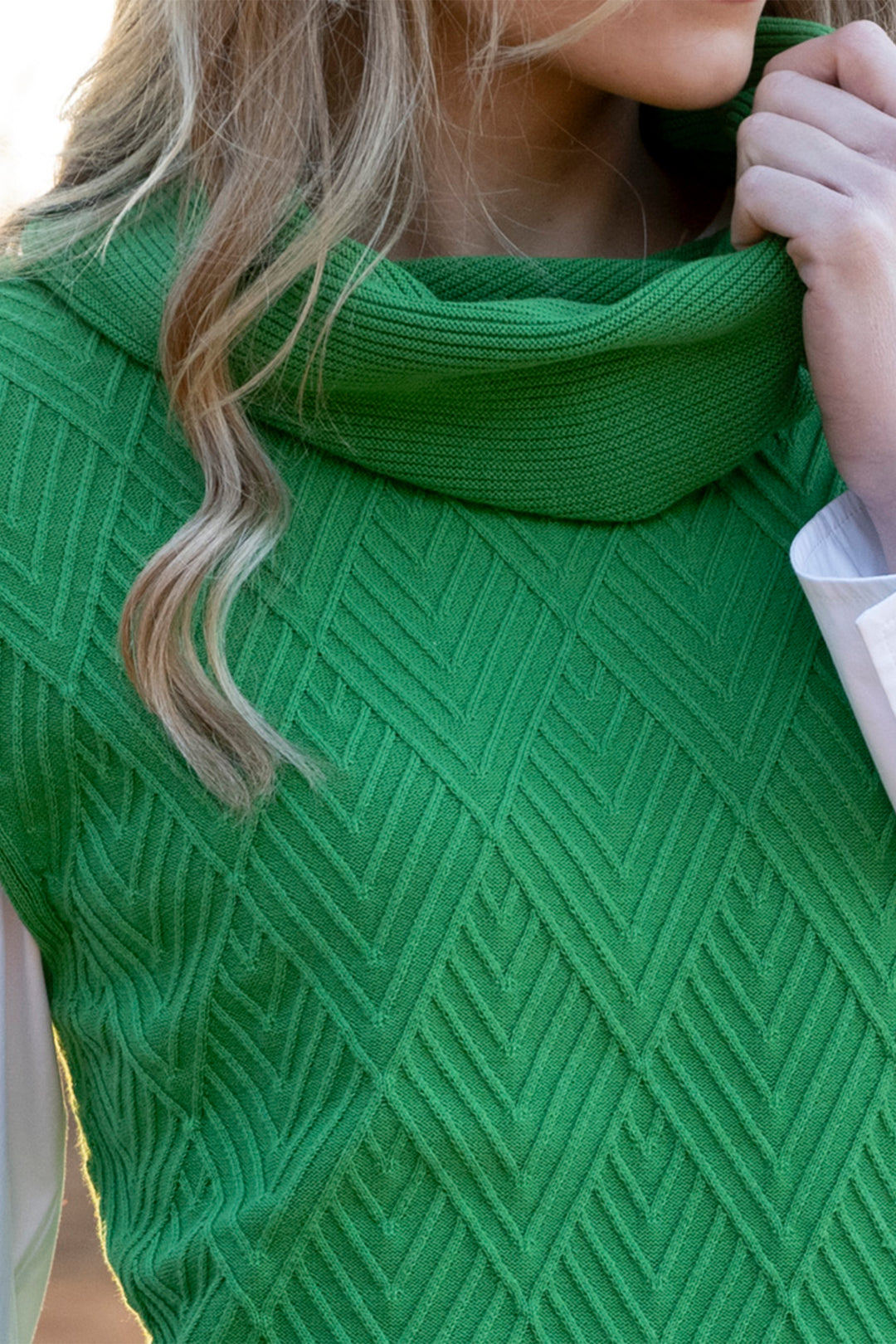 Green knitted cowl with a textured pattern