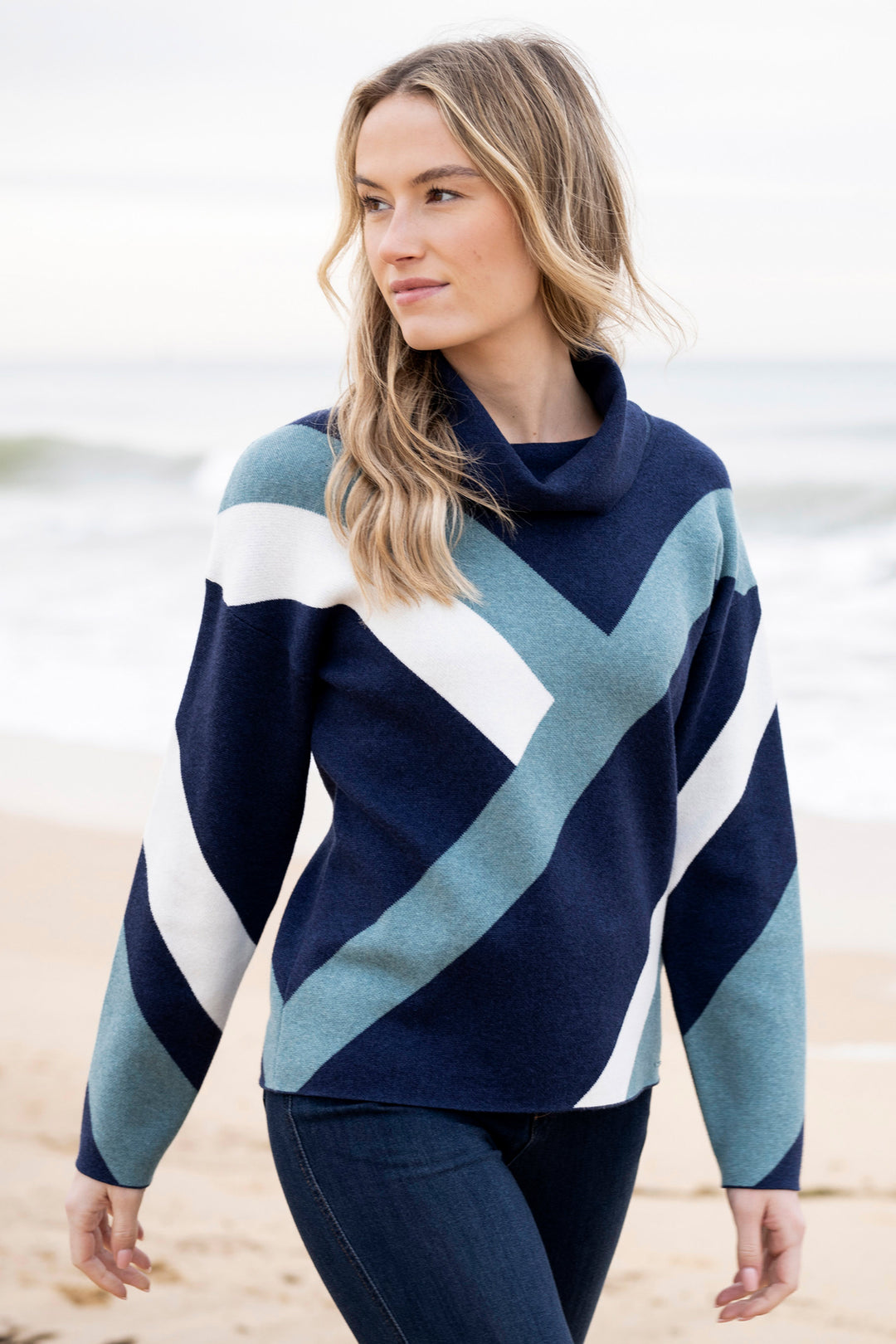 Woman wearing a blue and white striped sweater on a beach