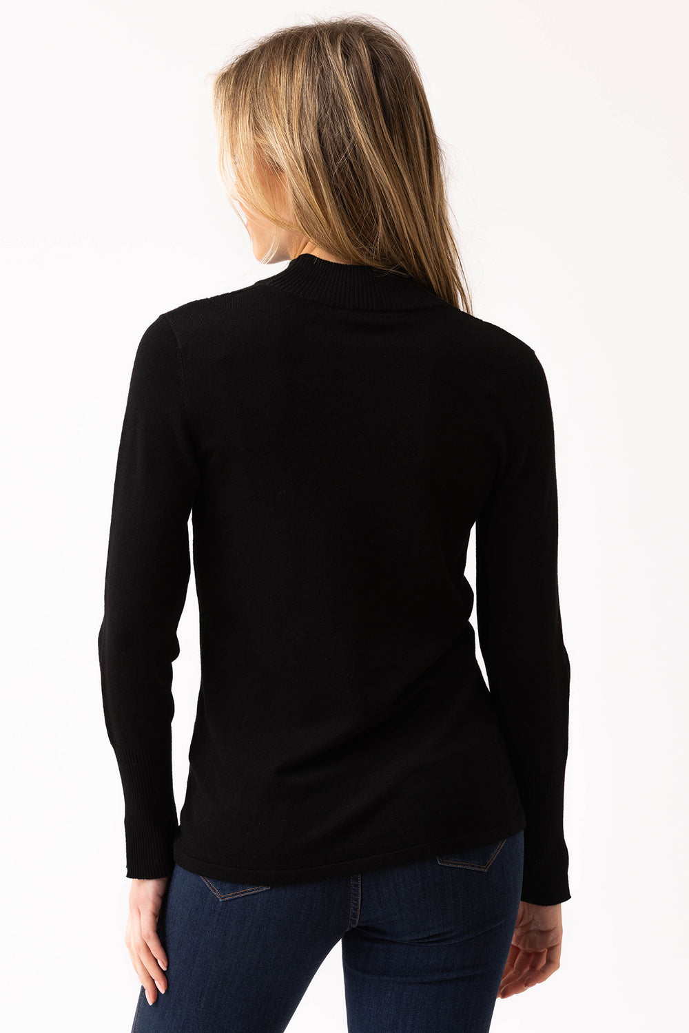 Person wearing a black long-sleeve top on a white background