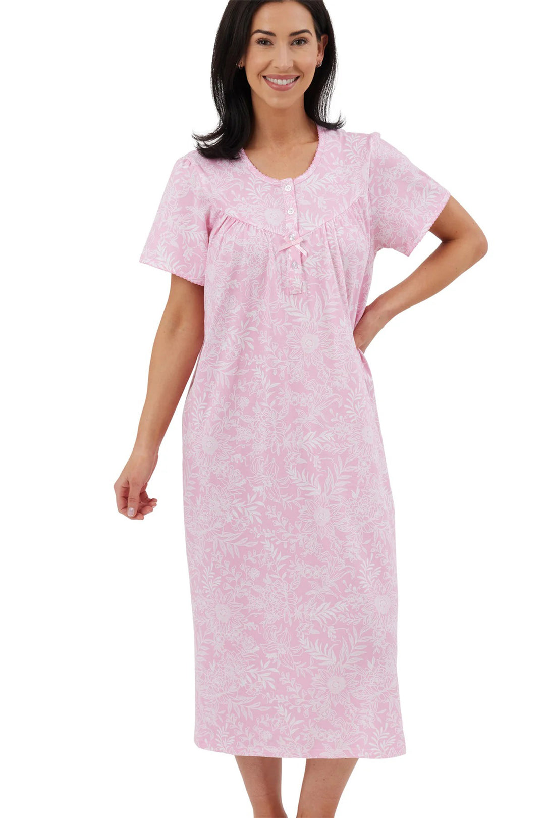 Woman wearing a pink patterned nightgown on a white background