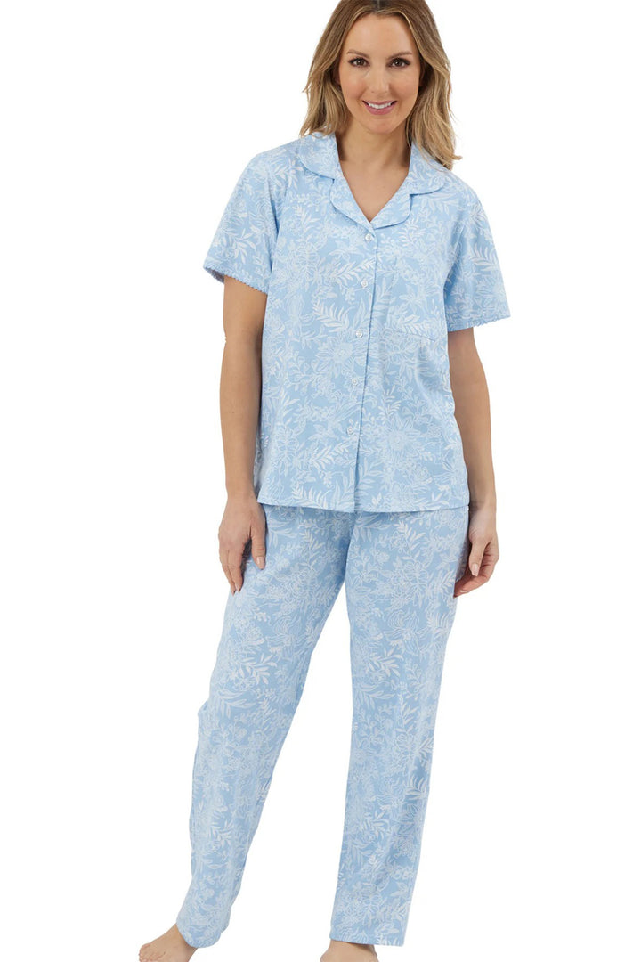 Woman wearing a light blue pajama set on a white background