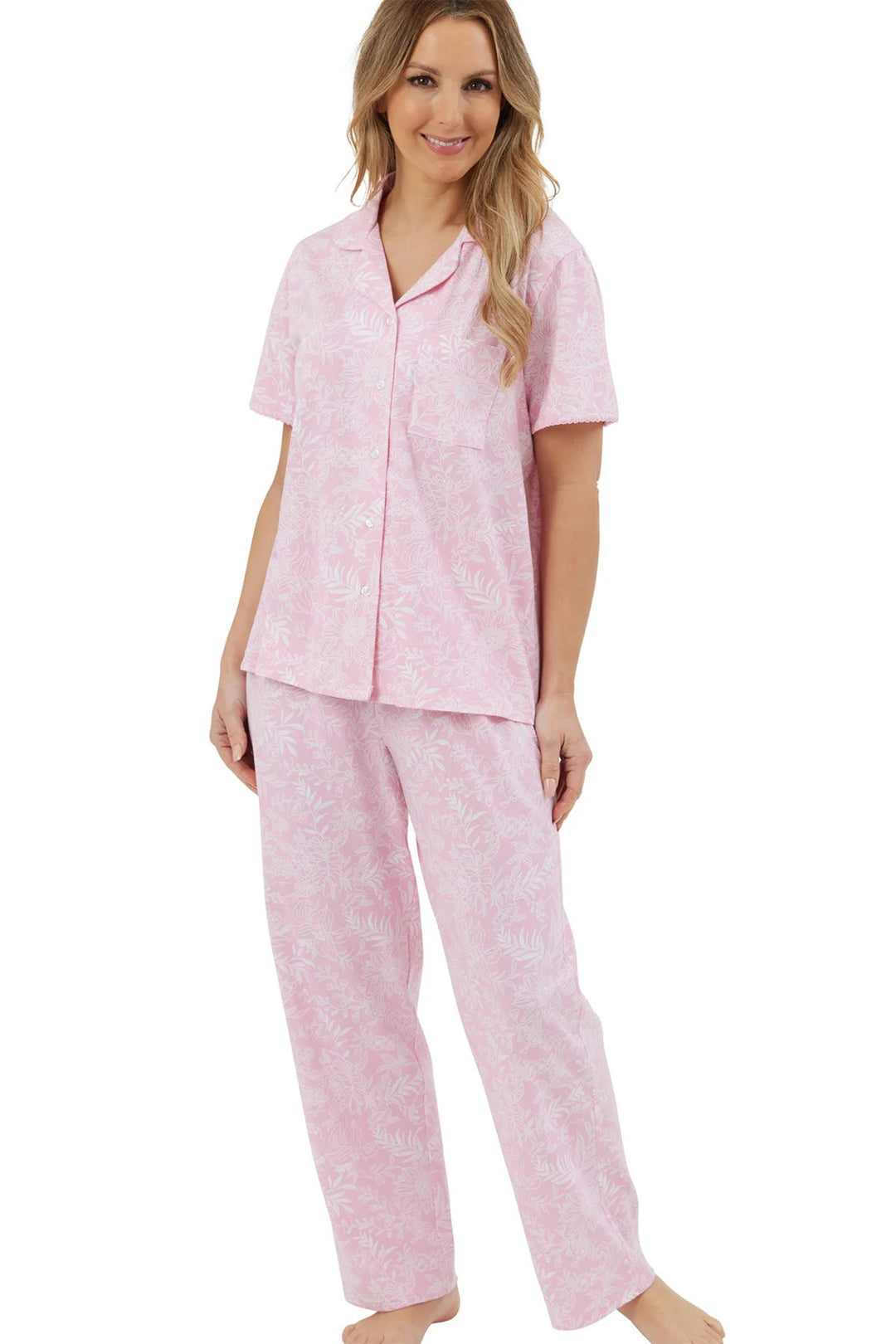 Woman wearing a pink pajama set on a white background
