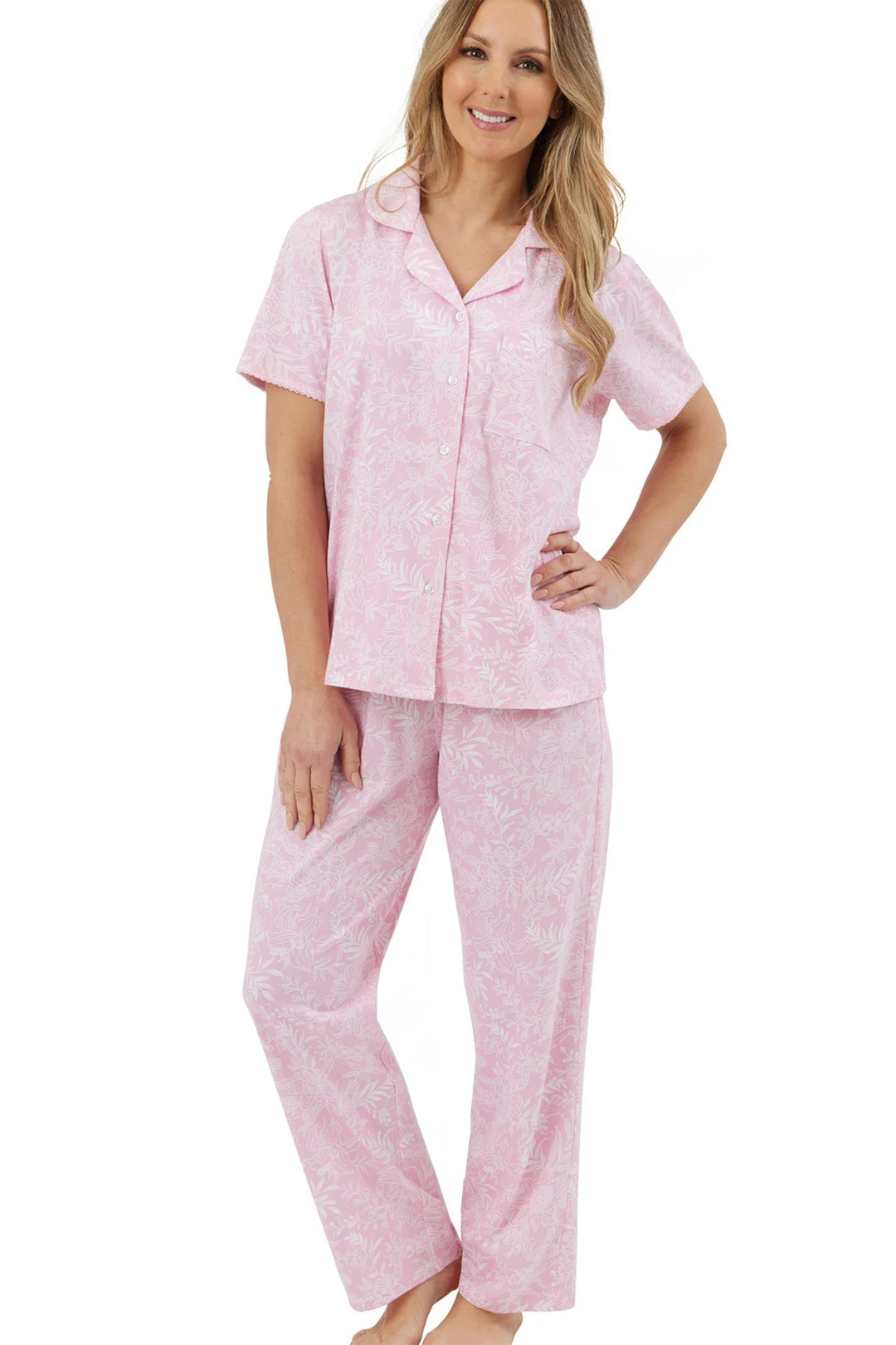 Woman wearing a pink pajama set on a white background