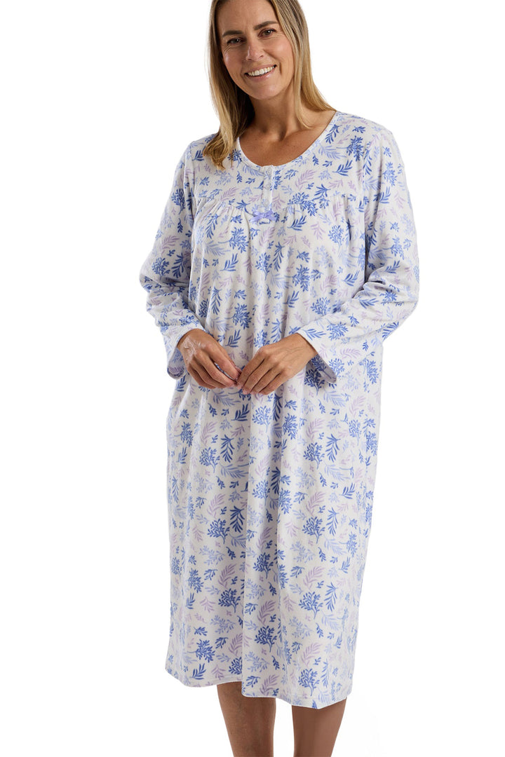 Woman wearing a floral nightgown on a white background
