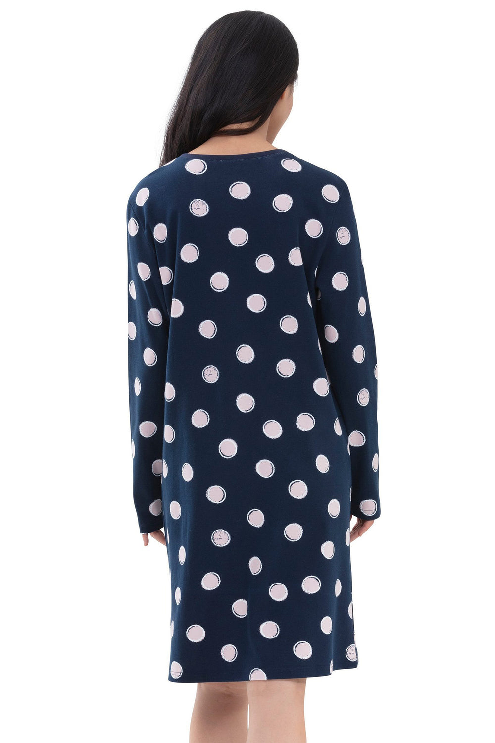 Navy dress with white polka dots worn by a person on a white background