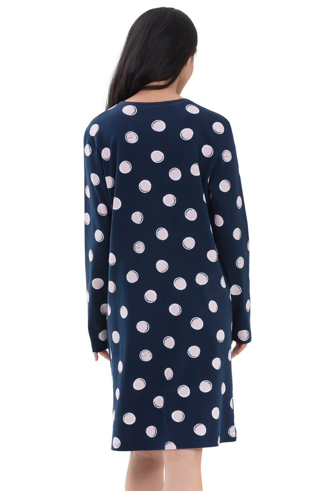Navy dress with white polka dots worn by a person on a white background