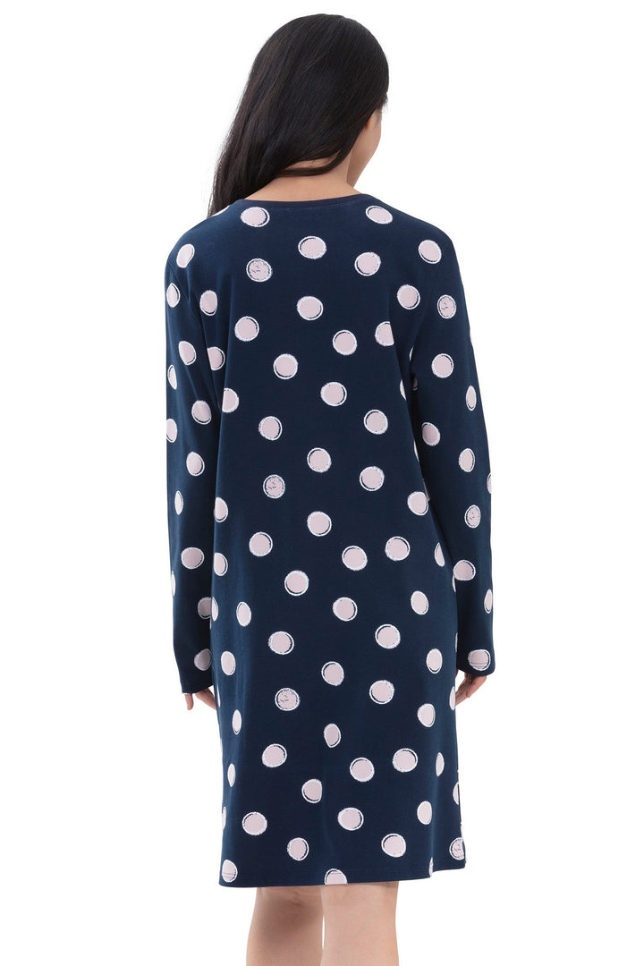 Navy dress with white polka dots worn by a person on a white background