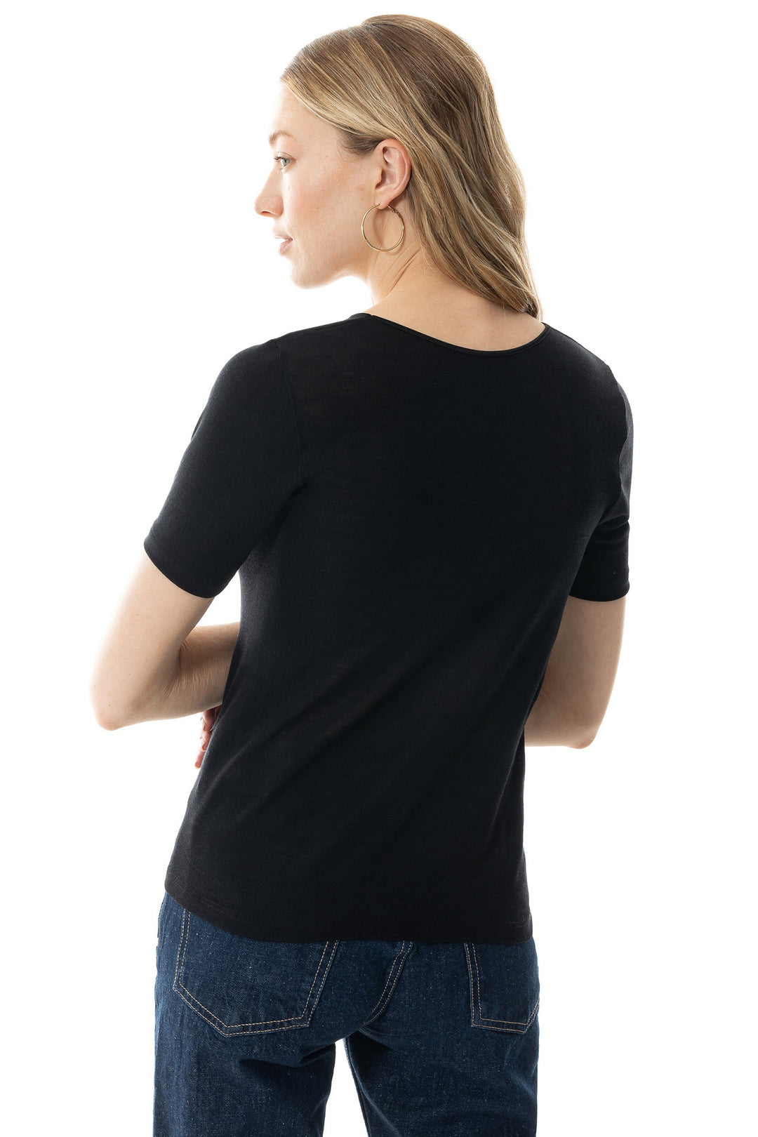 Person wearing a black t-shirt and blue jeans on a white background