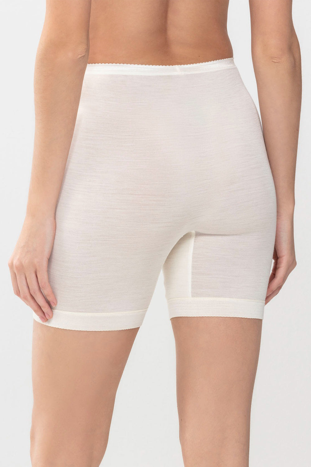 Beige shapewear shorts worn by a person on a white background