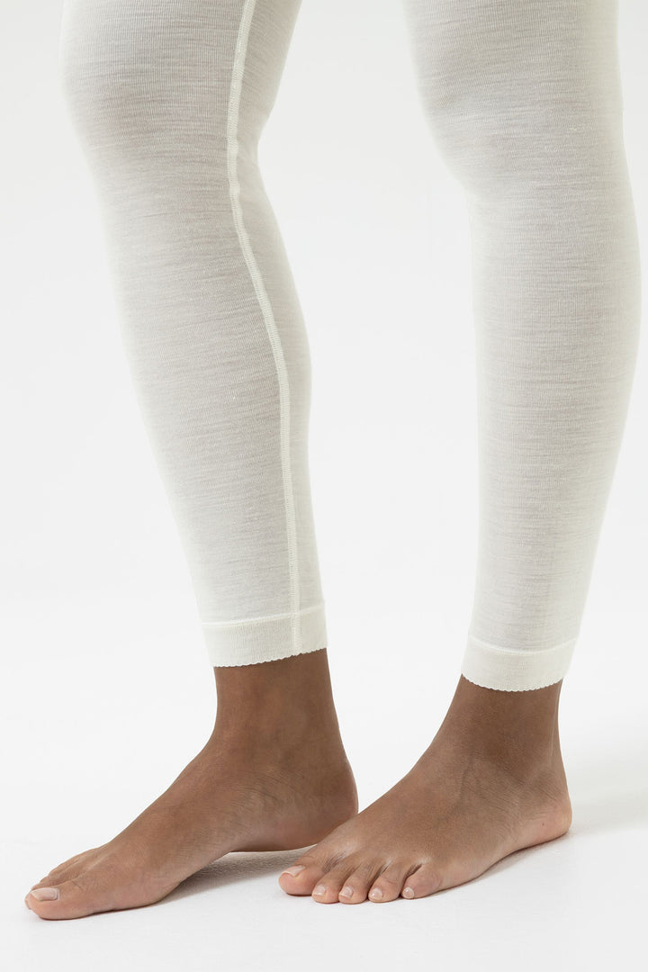 White leggings worn by a person on a white background