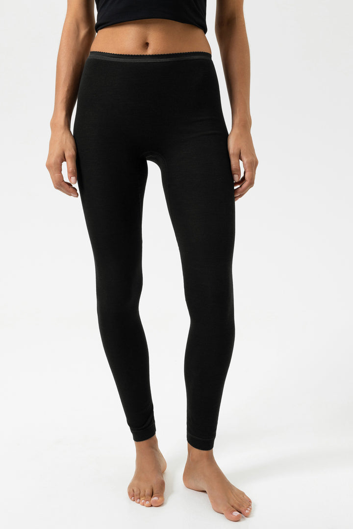 Person wearing black leggings on a white background