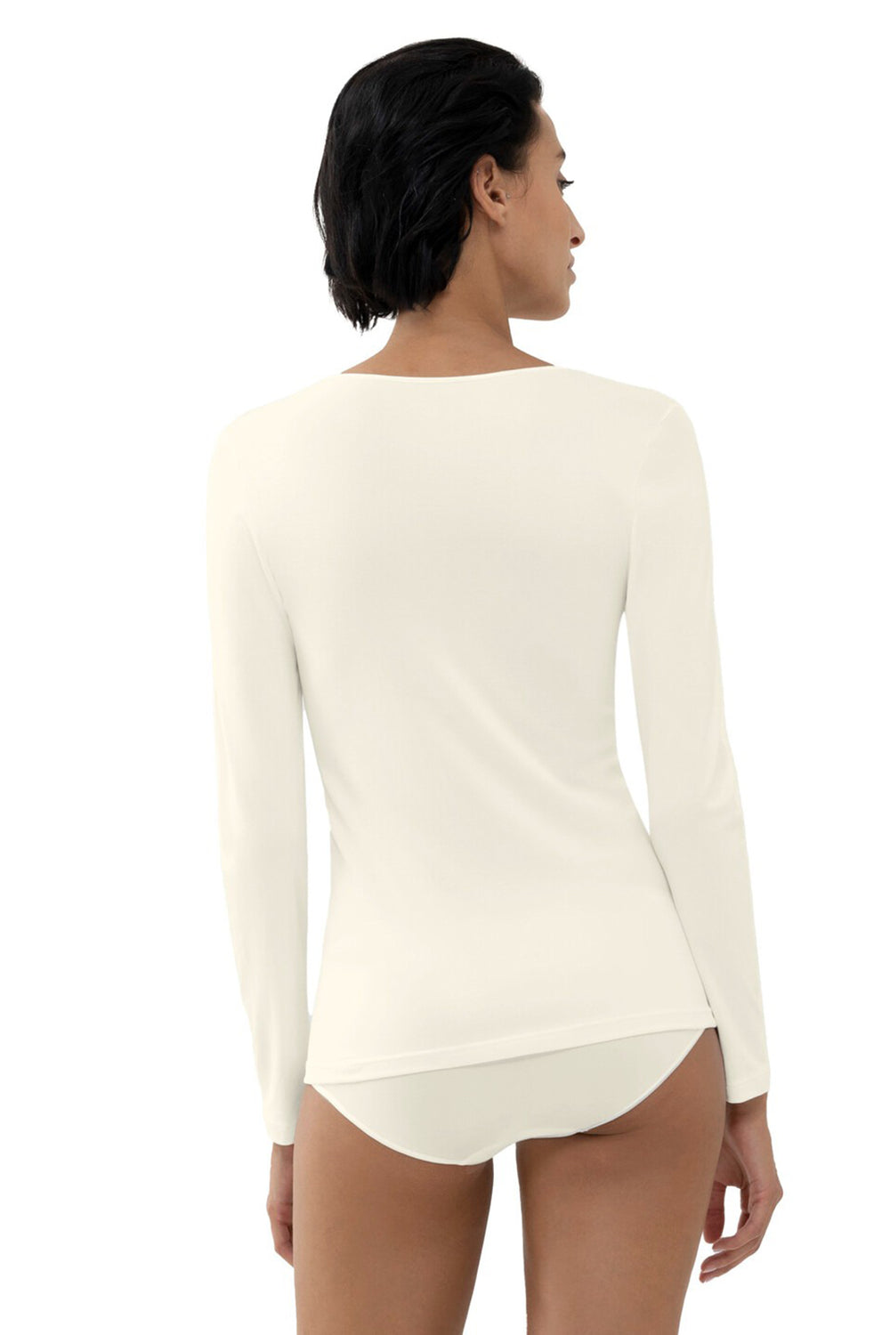 Woman wearing a white long-sleeve top and underwear set on a white background